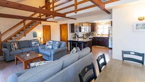 Un espacio habitable amplio con una escalera, una cocina y un comedor.