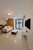 A modern living room with a sofa, coffee table, and TV.