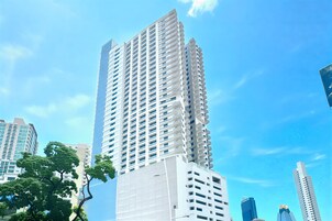 A tall, modern skyscraper with a grid-like facade and numerous windows.