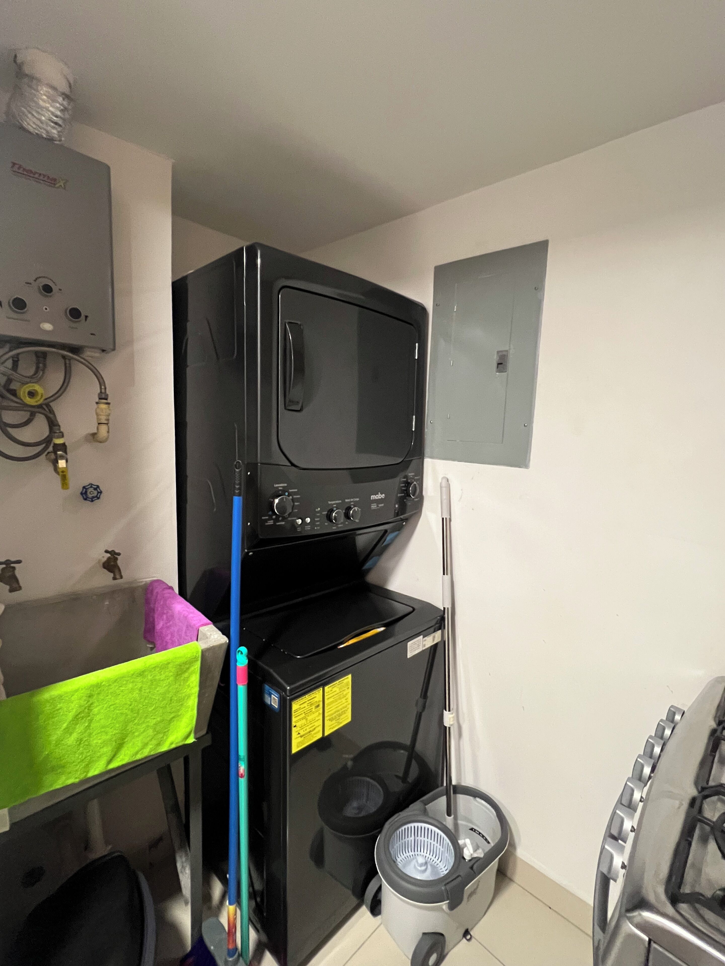 A kitchen with a microwave, a sink, and a gas stove.