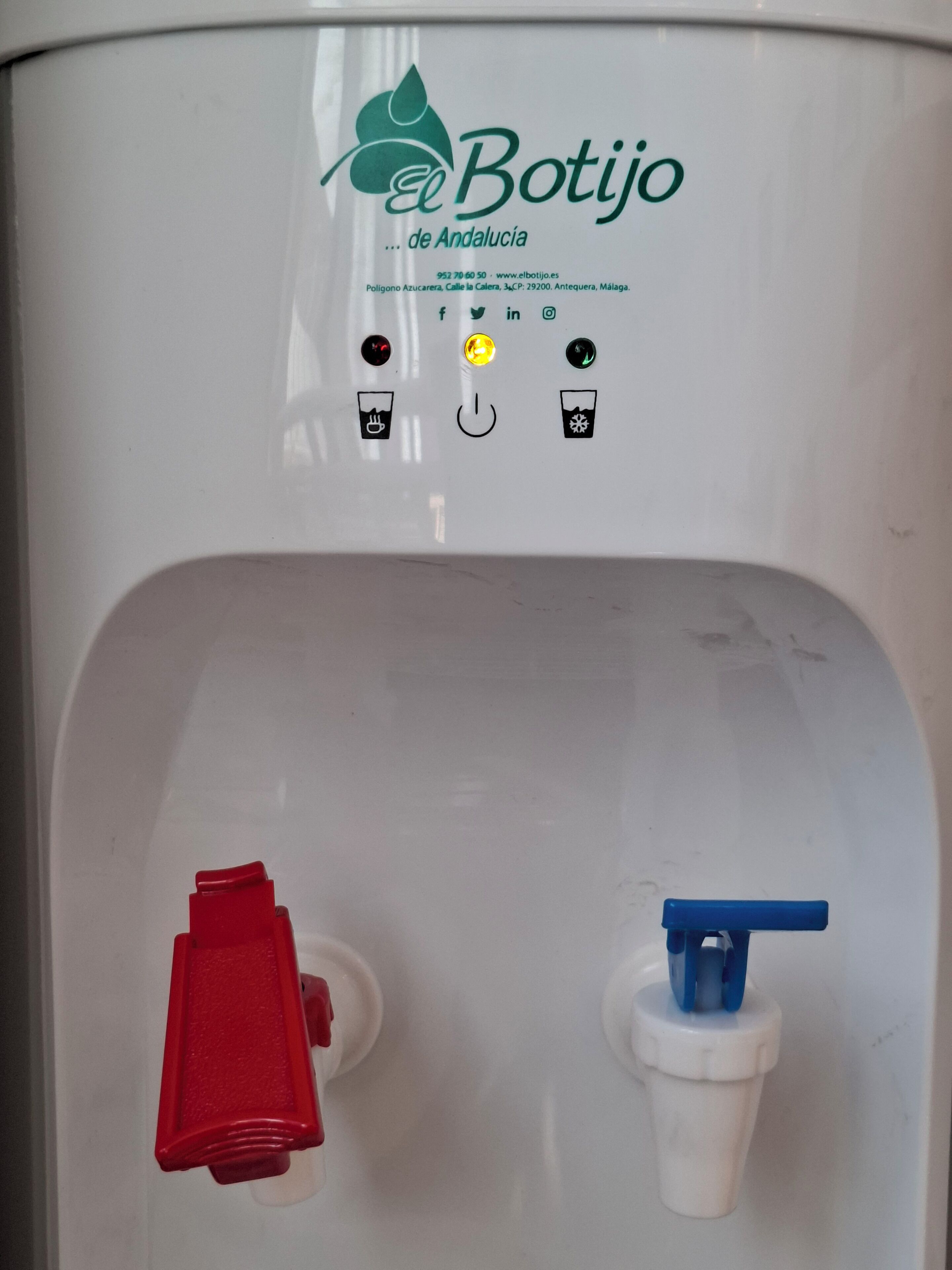 A water dispenser with a logo, contact information, and operational buttons.
