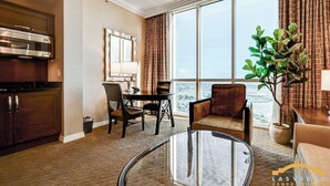 A hotel room with a kitchen, dining area, and a large window with a view. - MGM Signature 34-818 Jacuzzi Studio UpperPenthouse (Las Vegas)