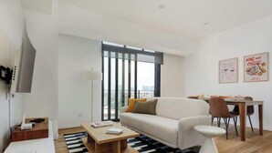 A modern living room with a sofa, coffee table, and dining area. - Magnificent Apartment in the Heart Nuevo Polanco (Mexico City)