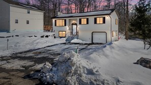 A two-story house with a garage and a front porch.