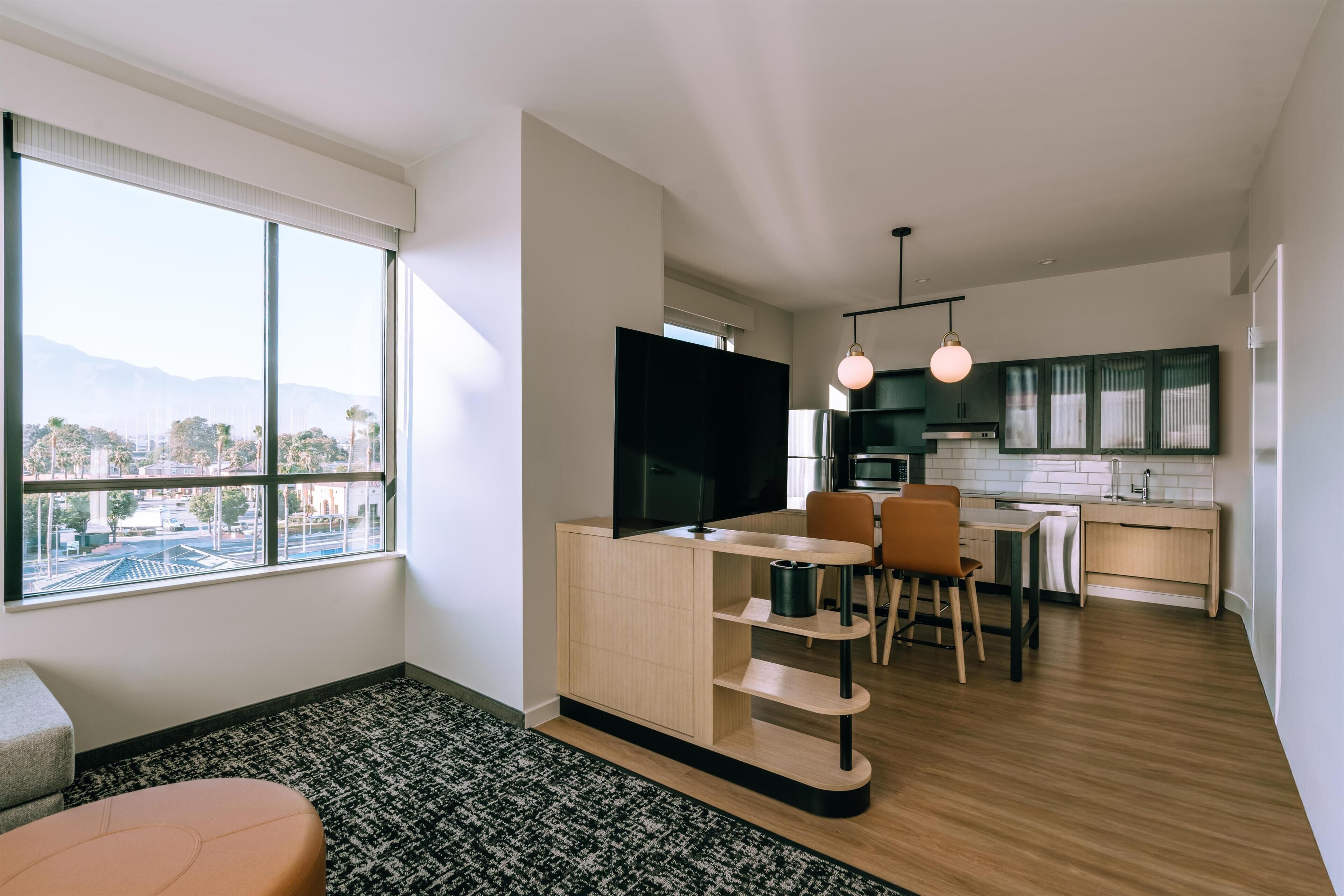 A modern apartment with a living area, dining space, and kitchen.