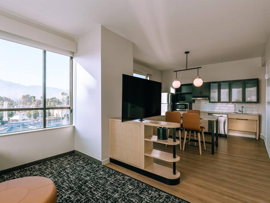 A modern apartment with a living area, dining space, and kitchen.
