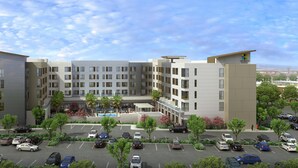 A multi-story hotel with a parking lot and landscaped areas. - Hyatt House Ontario Airport (Ontario)
