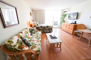 A living room with a sofa, a coffee table, a TV, and a cabinet. - Premium Bright City-View Retreat - Any Premium Rm (Honolulu)