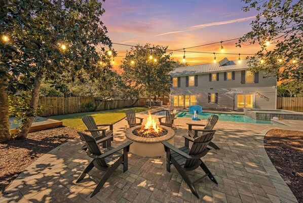 A backyard with a fire pit, outdoor seating, a swimming pool, and a house in the background. - Backyard Oasis, Pool,Sandy Magnolia, Sleeps 16,Eastern Lake,Golf Cart, Bikes (Santa Rosa Beach)