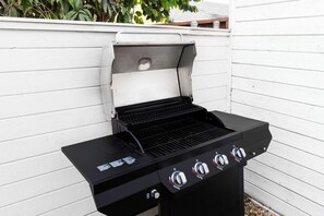 A black outdoor grill with a control panel, set against a white wall. - LA Oasis|Jacuzzi|Parking|Fireplace| Prime Location (Los Angeles)