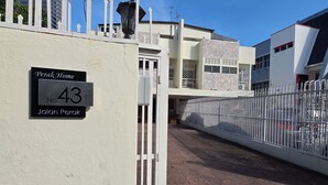 A gated entrance to a residential area with a sign indicating 'Perak Home No. 43 Jalan Perak'. - Room at Macalister near to LohGuanLye (George Town)