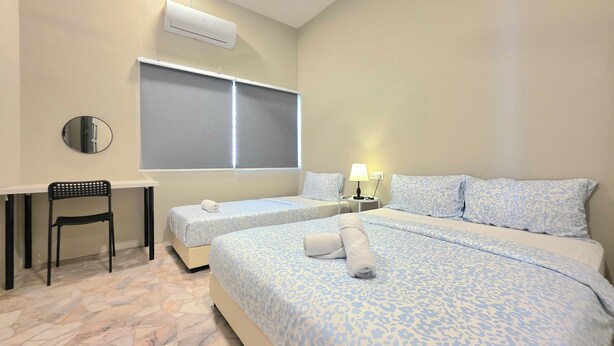 A hotel room with two beds, a desk, a chair, and an air conditioning unit. - Room at Macalister near to LohGuanLye (George Town)