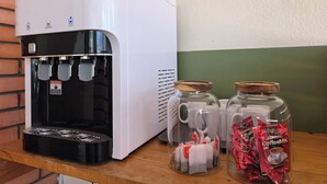 A coffee machine with multiple spouts, two glass jars with lids, and packets of coffee mix. - Room at Macalister near to LohGuanLye (George Town)