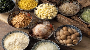Various food items in bowls on a wooden surface. - REGIONIA by Quintessa Sapporo Sta. Front (Sapporo)