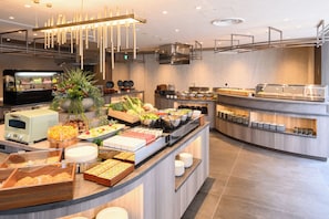 A buffet setup with various food items and a self-service station. - REGIONIA by Quintessa Sapporo Sta. Front (Sapporo)