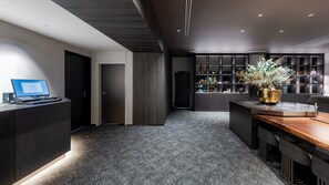 A modern interior with a desk, laptop, and a bookshelf. - REGIONIA by Quintessa Sapporo Sta. Front (Sapporo)