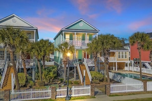 A multi-story house with a balcony, palm trees, and a swimming pool. - Beach house in Heart of Surfside Beach, SC (Surfside Beach)