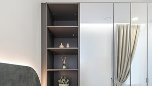 A bedroom with a bed, a wardrobe, and a small wooden table. - Vytauto 43 Residence – Lietūkis by Domvia (Kaunas)