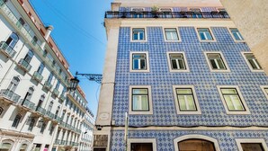 A building with a blue-tiled facade, multiple windows, and balconies. - Trendy Flat in the iconic Chiado (Lisbon)