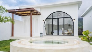 A modern house with a large circular pool, a pergola, and a view of the surrounding landscape. - Lazura Serenite (Kintamani)
