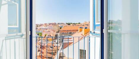 An open balcony with a view of a cityscape.