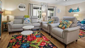 A living room with a sofa set, two side tables, a coffee table, and a colorful rug. - Intracoastal Townhome with Private Entrance, Beach Equipment, and Bikes! (Indian Shores)