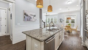 A modern kitchen with granite countertops, stainless steel appliances, and a central island. - 🌟 *New* Prominence 30A | Heated Pool | Golf Cart | Bikes 🚲 (Inlet Beach)
