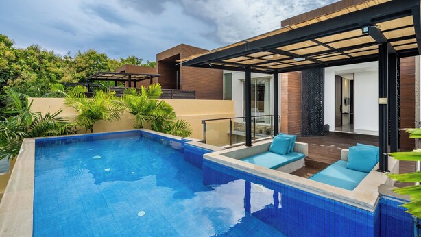 A swimming pool with a sun terrace and outdoor seating. - Bhiseka Villa Nusa Dua by Aishwarya Bali (Nusa Dua)