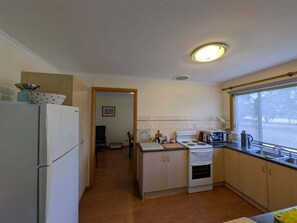 Fridge, microwave, cookware/dishes/utensils, dining tables