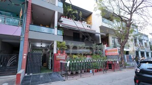 A multi-story building with a gated entrance, potted plants, and a sign for 'Dream Home Stay'. - Dream Homestay (Ujjain)