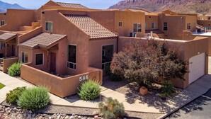 A residential building with a flat roof, multiple windows, and a visible garage door. - Easy, comfortable stay near Moab's best adventures (Moab)