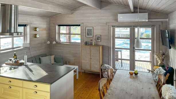 A kitchen with a wooden ceiling, a dining area with a table and chairs, and a window with a view of the outside. - Beautiful home in Vordingborg with WiFi (Vordingborg)