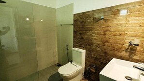 A bathroom with a glass shower enclosure, a toilet, and a sink. - Kandy Hotel Riverline Resort (Kandy)