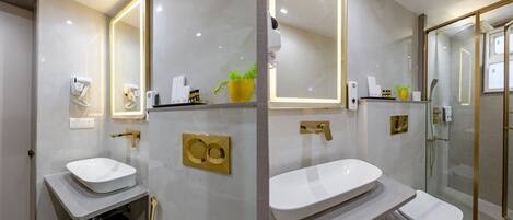 A modern bathroom with a large mirror, a sink, a toilet, and a shower area.