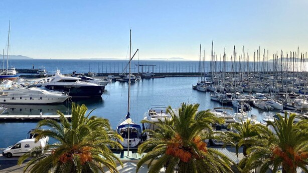 A marina with multiple boats docked, palm trees in the foreground, and a clear sky. - House for 6 guests with air conditioning and Wi-Fi – Hyères Port (HYERES)