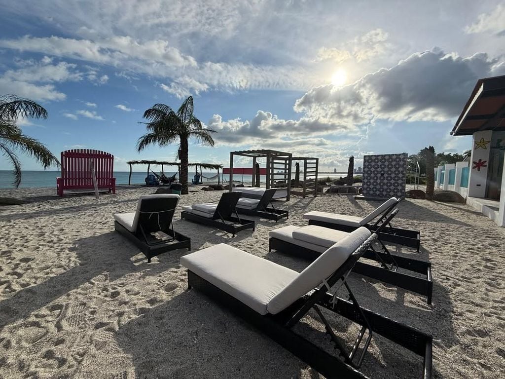 On the beach, black sand, free beach cabanas, sun loungers