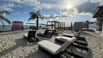 On the beach, black sand, free beach cabanas, sun loungers