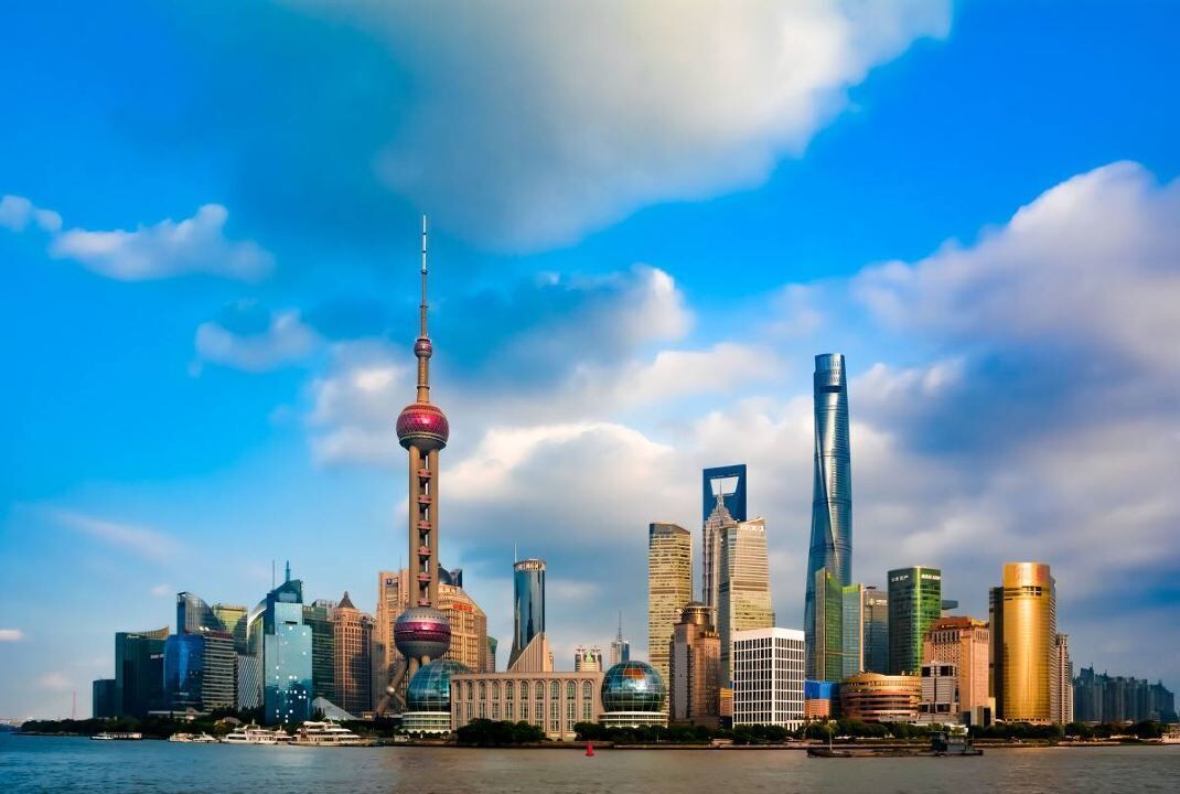 A city skyline with modern skyscrapers, including a distinctive tower with a spherical observation deck.