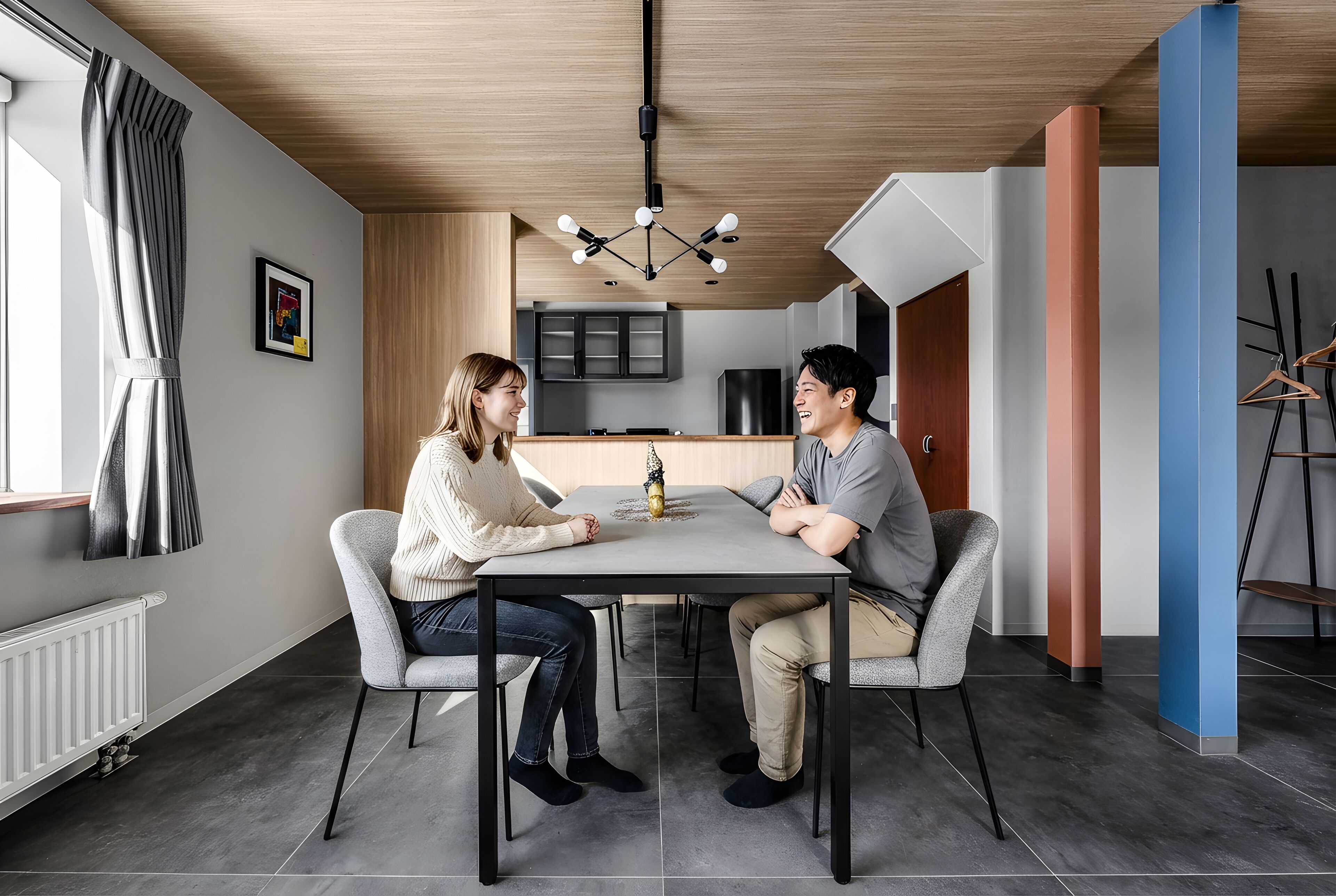 A modern kitchen with dark cabinets, a wooden ceiling, and a central island.