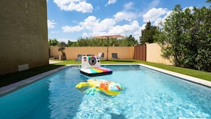 A swimming pool with a colorful inflatable crab toy and a floating camera. - Villa in Vias With Private Pool & Garden (Vias)