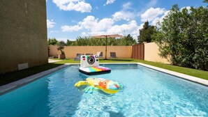 A swimming pool with a colorful inflatable crab toy and a floating camera. - Villa in Vias With Private Pool & Garden (Vias)