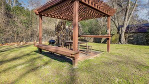 A wooden gazebo with benches and tables, surrounded by trees and a grassy area. - 1 Mi to Park Circle: Pet-Friendly Home w/ Yard (North Charleston)