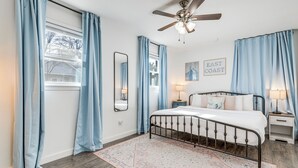 A bedroom with a bed, nightstands, a ceiling fan, and a window with curtains. - 1 Mi to Park Circle: Pet-Friendly Home w/ Yard (North Charleston)