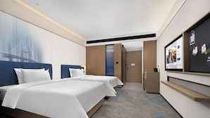 A hotel room with two beds, a TV, and a desk. - Hampton by Hilton Yichun  (Yichun)
