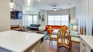 A modern living room with a sofa, chairs, a dining table, and a TV. - 6 Mi to Broadway: Nashville Townhome w/ Balcony! (Nashville)