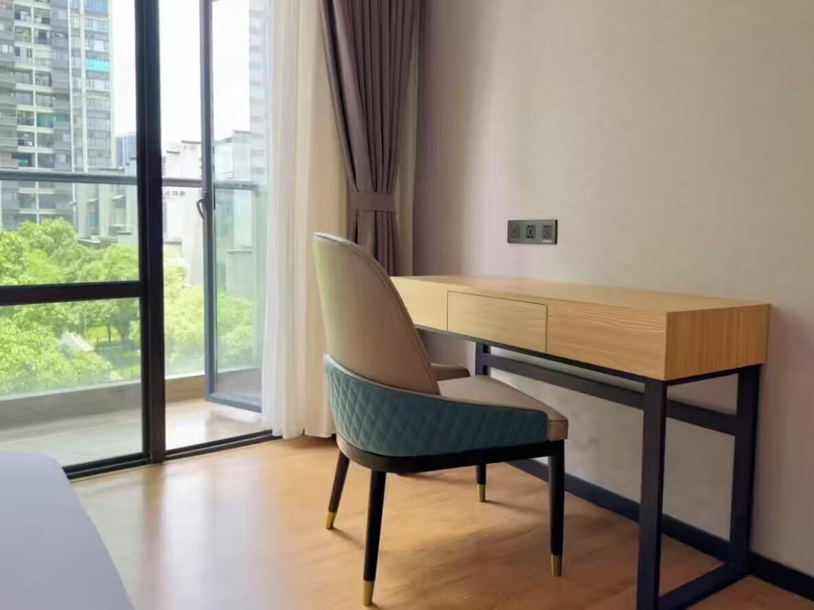 A modern room with a large window, a desk, and a chair.