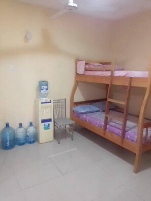 A bunk bed room with a water dispenser and three water bottles. - Furnished Flat Apartment Bamburi Beach Mombasa (Mombasa)