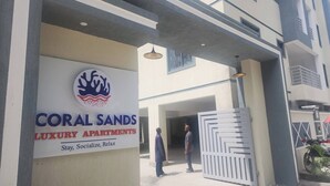 The entrance to Coral Sands Luxury Apartments with a signboard and a gated entrance. - Private Stylish Flat in Nyali Mombasa with Pool near Beach (Mombasa)