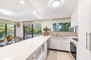 Fridge, microwave, oven, stovetop - Surf Parade Family Getaway - WiFi, Parking, Pool (Broadbeach)