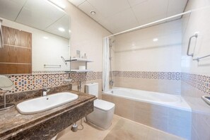 A modern bathroom with a marble sink, a bathtub, and a shower. - Unit 805 Jamam Residence (Abu Dhabi)